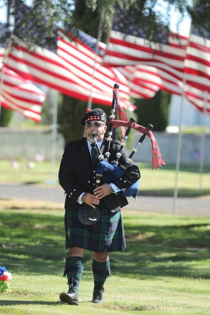 A man in a kilt playing the bagpipes